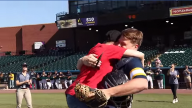 Marine surprises his mom when she throws the first pitch!
